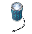 2″ Bluetooth speaker with portable flashlight in fabric finish. 