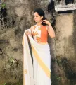Orange Floral Print Mix Sleeveless O Neck Ribbed Saree Jacket For Women. 