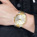 SKMEI 9323 Luxury Stainless Steel Strap Date week Watch Fashion Japan movement Golden Tuton - Men. 