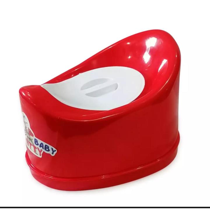 Small Baby Sitting on a Potty, Baby Toilet, Place for Text Stock Photo