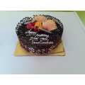 2 Pound Chocolate Garnished With Fruits Cake. 