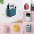 Mobile charging stand remote holder self adhesive wall mounted Mobile phone charging stand. 