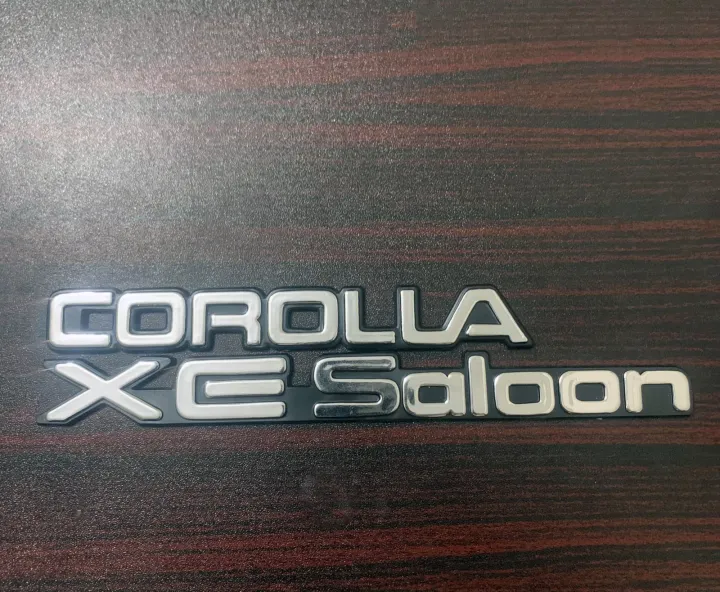 Pack%20of%202%20COROLLA%20XE-Saloon%20Monogram%20Plastic%20Emblem%20For%20Toyota%20Corolla%2089-94%20-%20Image%205