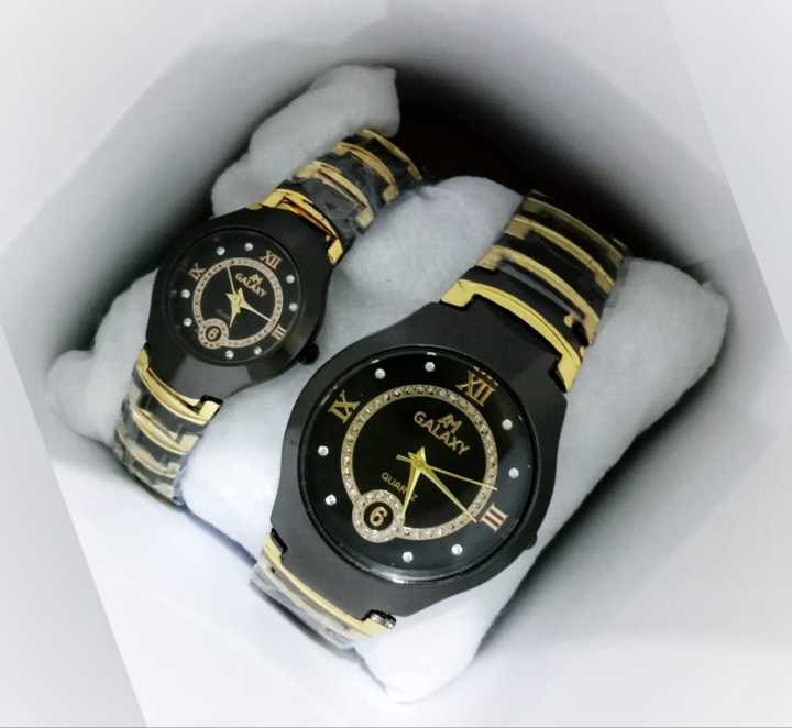 A classic analog wristwatch with a white dial, black Arabic numerals, and a white leather strap.