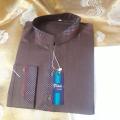brown colour kurta and white colour shalwar. 