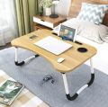 Black wooden foldable laptop table. 