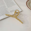 The Hair Edit Gold French Twist Claw Clip. 