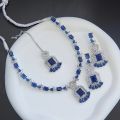Necklace zircon jewellery set with earrings and maang tikka, all beautifully adorned with different colours stones that resemble emeralds or aquamarines.. 