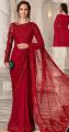 An elegant saree featuring bejewelled neckline and delicate embroideries, pearls, diamonites, sequins and hand cut 3D floral appliques with signature sophisticated cutwork detaling in an ethereal shade of Red.. 