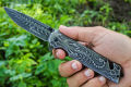 Foldable pocket knife with a scorpion pattern. 