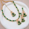 Necklace zircon jewellery set with earrings and maang tikka, all beautifully adorned with different colours stones that resemble emeralds or aquamarines.. 