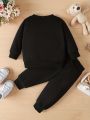 "Keep Your Baby Boy Stylish and Comfy with a King Letter Print Tracksuit - King Letter Print Sweatshirt & Trousers Set". 