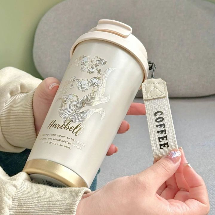 Harebell%20Premium%20Travel%20Coffee%20Mug%20%7C%20Double%20Wall%20Stainless%20Steel%20Vacuum%20Insulated%20Tumbler%20with%20Leak-Proof%20Flip%20Lid%20&%20Carry%20Strap%20%E2%80%93%20Elegant%20White%20Gold%20Floral%20Design%20%7C%20Reusable%20Hot%20&%20Cold%20Beverage%20Cup%20for%20Office,%20Home%20&%20Outdoor%20Use%20%E2%80%93%20500ml%20-%20Image%202