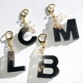 Initial keychain- Black and golden-  fancy keychain- Resin-  Epoxy - Matt Black Color. 