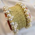 Trendy metal bangles set with pearl bangles golden dotted pearl bangles set bangles for girls in all sizes and colors. 