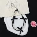 Korea ins pearl bow ribbon mobile phone chain lanyard versatile black and white hanging ornament small fragrance wind beaded pendant. 