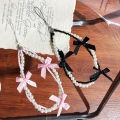 Korea ins pearl bow ribbon mobile phone chain lanyard versatile black and white hanging ornament small fragrance wind beaded pendant. 