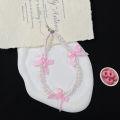 Korea ins pearl bow ribbon mobile phone chain lanyard versatile black and white hanging ornament small fragrance wind beaded pendant. 