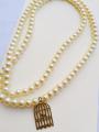 Girls beautiful pearl necklace with cage pendant with cream colour. 