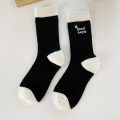 Medium socks women's winter thick small fragrance embroidery camellia cashmere socks ins tide black and white wool socks wholesale. 