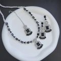 Necklace zircon jewellery set with earrings and maang tikka, all beautifully adorned with different colours stones that resemble emeralds or aquamarines.. 
