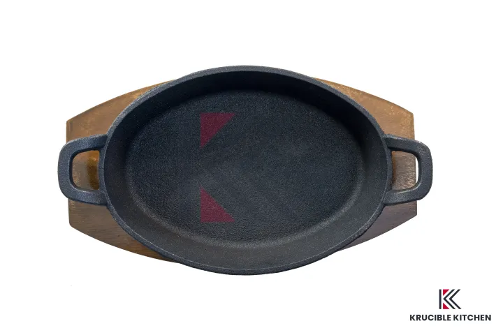 cast%20iron%20Sizzler%209"%20(22.7%20CM),%20Oval%20Deep%20with%20Wooden%20Base,%20Krucible%20Kitchen,%20Cast%20Iron%20Naturally%20Non%20Stick,%20Serving%20-%20Image%207