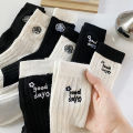 Medium socks women's winter thick small fragrance embroidery camellia cashmere socks ins tide black and white wool socks wholesale. 