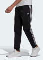 Adidas ESSENTIALS WARM-UP TAPERED 3-STRIPES TRACK PANTS. 