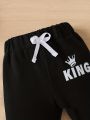 "Keep Your Baby Boy Stylish and Comfy with a King Letter Print Tracksuit - King Letter Print Sweatshirt & Trousers Set". 