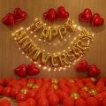 Romantic Happy Anniversary Surprise for Husband, Wife with Heart Shape Balloons, Happy Anniversary Letters, and Golden and red Balloons and Fairy Light. 