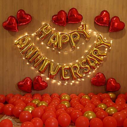Romantic Happy Anniversary Surprise for Husband, Wife with Heart Shape Balloons, Happy Anniversary Letters, and Golden and red Balloons and Fairy Light