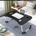 Black wooden foldable laptop table. 