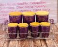 7-Piece Airtight Ceramic Canister Set with 3 Large and 4 Small Canisters on Metal Rack. 