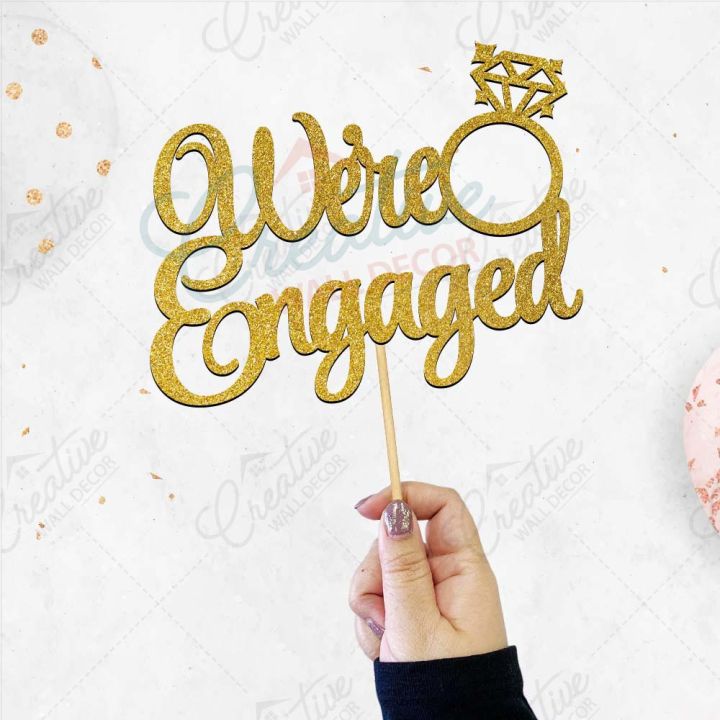 We're%20Engaged%20Cake%20Topper%20for%20Cake%20Decoration,%20Wedding%20Anniversary%20&%20Engagement%20Party%20Celebration%20Toppers%20in%20Gold%20-%20Image%203