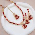Necklace zircon jewellery set with earrings and maang tikka, all beautifully adorned with different colours stones that resemble emeralds or aquamarines.. 