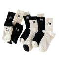 Medium socks women's winter thick small fragrance embroidery camellia cashmere socks ins tide black and white wool socks wholesale. 