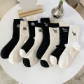 Medium socks women's winter thick small fragrance embroidery camellia cashmere socks ins tide black and white wool socks wholesale. 