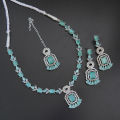 Necklace zircon jewellery set with earrings and maang tikka, all beautifully adorned with different colours stones that resemble emeralds or aquamarines.. 