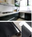 Durable 24x108 Inch Self-Adhesive PVC Sticker Paper for Home Use - Ideal for Cabinets, Fridges, Tables, and Furniture - Waterproof Protection sheet in black. 