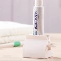 Rolling Tube Toothpaste Squeezer Dispenser Toothpaste Seat Holder Stand. 