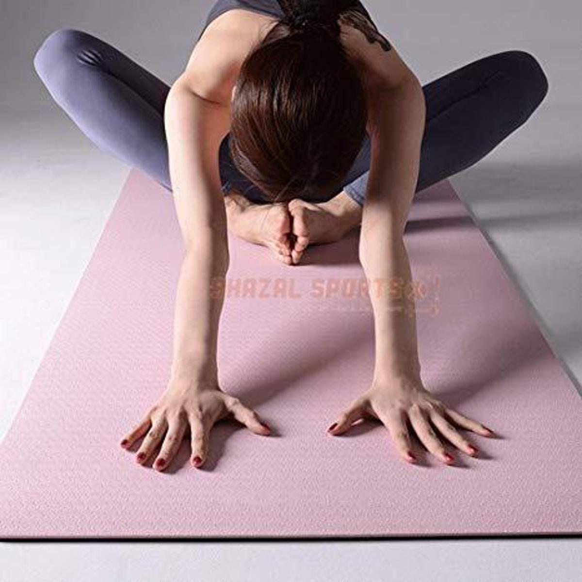 Yoga mats of different thicknesses rolled up side by side