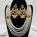 Artificial Gold-Plated White Pearl Mala with Artificial stones, a whole set including earrings with artificial stones and gold plating. 