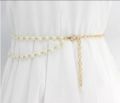 Elegant white pearls and golden chain belt for stylish girls. 