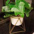 Ceramic pot with plant and metallic stand. 