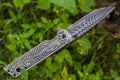 Foldable pocket knife with a scorpion pattern. 