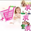 Toy shopping cart with baby toys. 