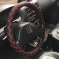 STEERING WHEEL COVER WITH RED STICHING/ RED THREAD DESIGN. 