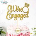 We're Engaged Cake Topper for Cake Decoration, Wedding Anniversary & Engagement Party Celebration Toppers in Gold. 