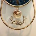 NEW 3D GLASS WALL CLOCK WITH SCREW HORN GOAT STRUCTURE ON TOP AND ROUND GLASS BOTTOM WITH PENDULUM FANCY AND ATTRACTIVE CLOCK IN BLACK GOLD COLOUR STYLISH DESIGN SMOOTH MACHINE WALL CLOCK HANGING WALL CLOCK HOME DECORATION PERFECT FOR YOUR LIVING ROOM. 