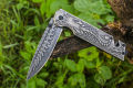 Foldable pocket knife with a scorpion pattern. 